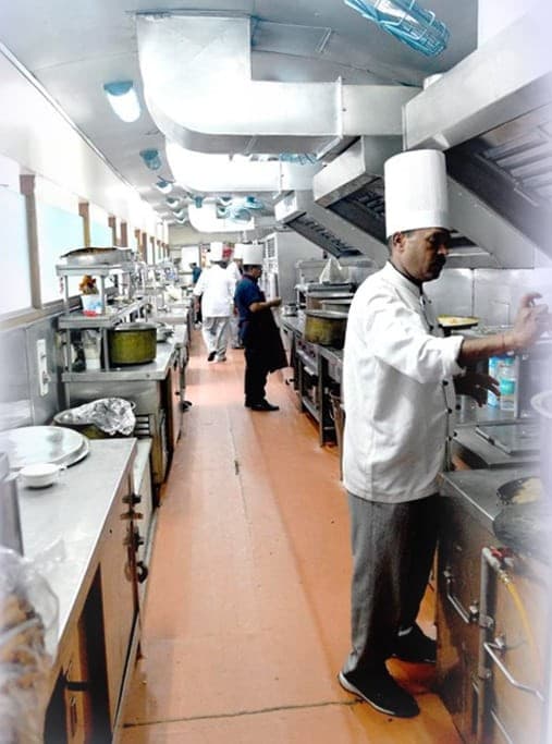 Chefs cooking in the onboard kitchen car